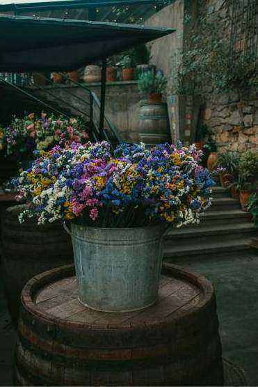 Hands arranging seasonal blooms
